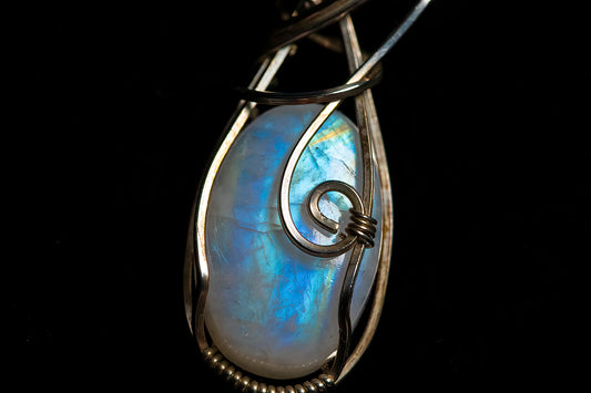 Thick, oval moonstone with fancy bale, wrapped in .925 sterling silver