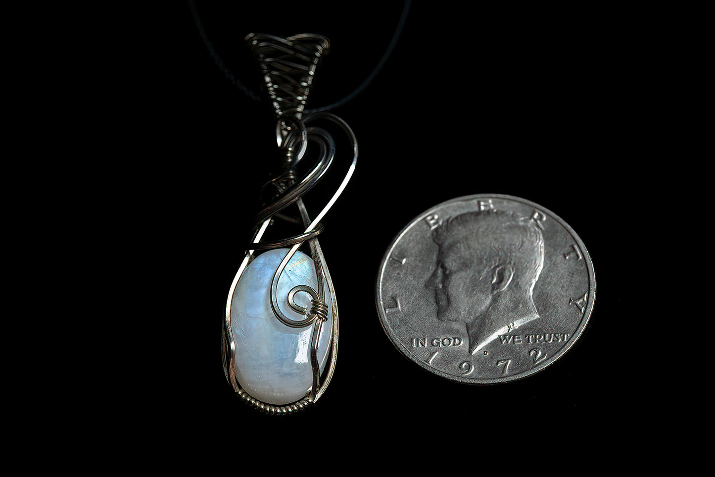 Thick, oval moonstone with fancy bale, wrapped in .925 sterling silver