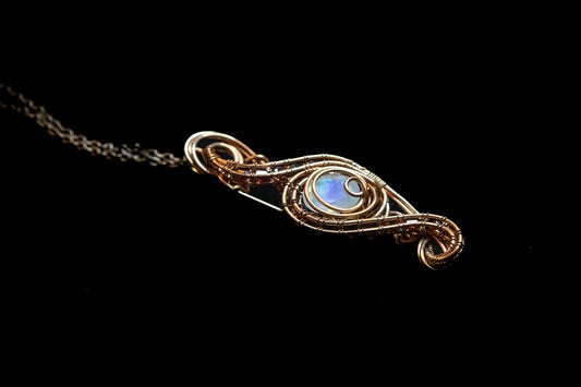 Faceted Madagascar Rainbow Flash Moonstone nestled in Fine Copper and surrounded by a multitude of Garnet Facets
