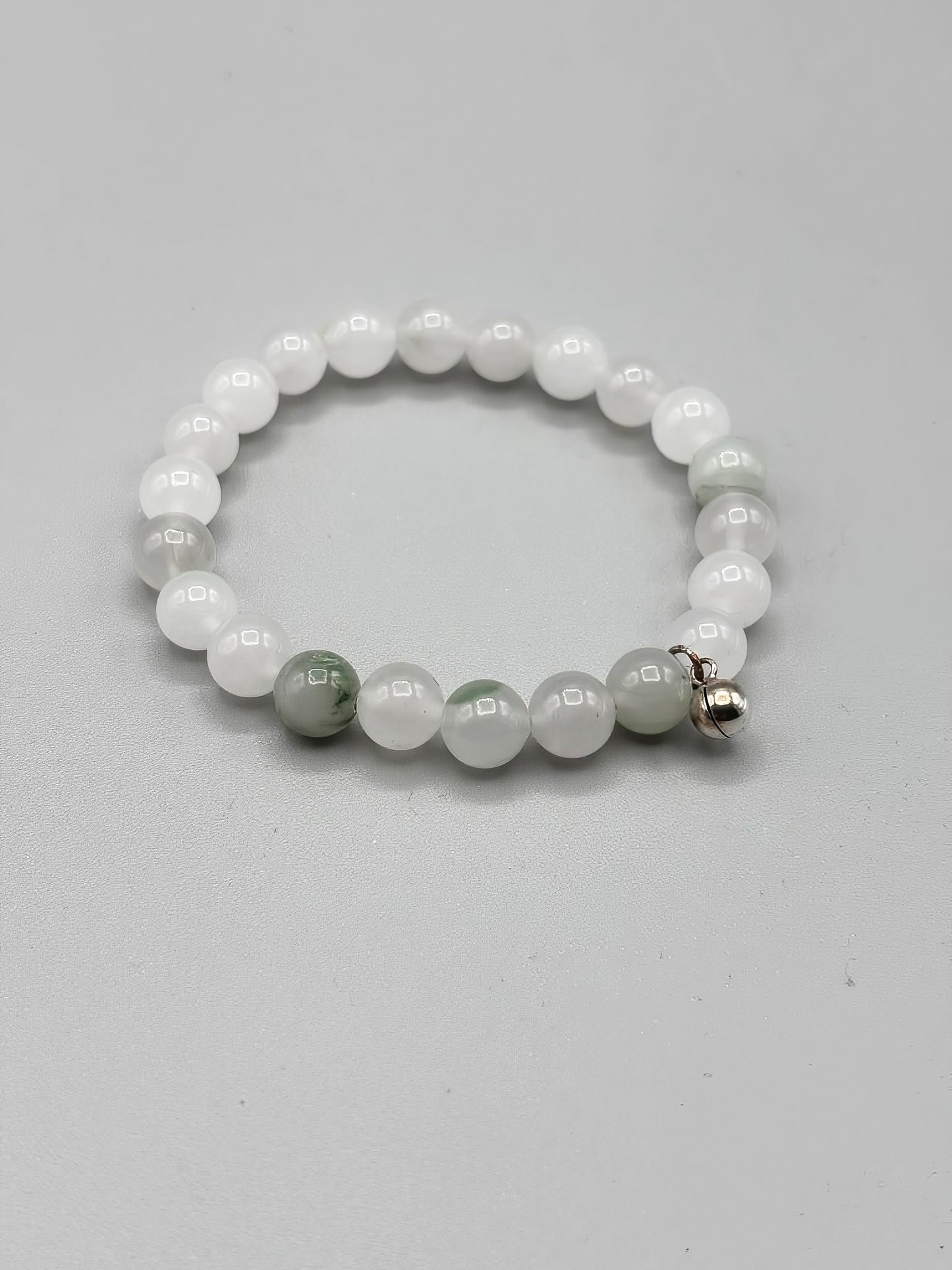 7 inch Jade beaded bracelet with sterling silver chime charm
