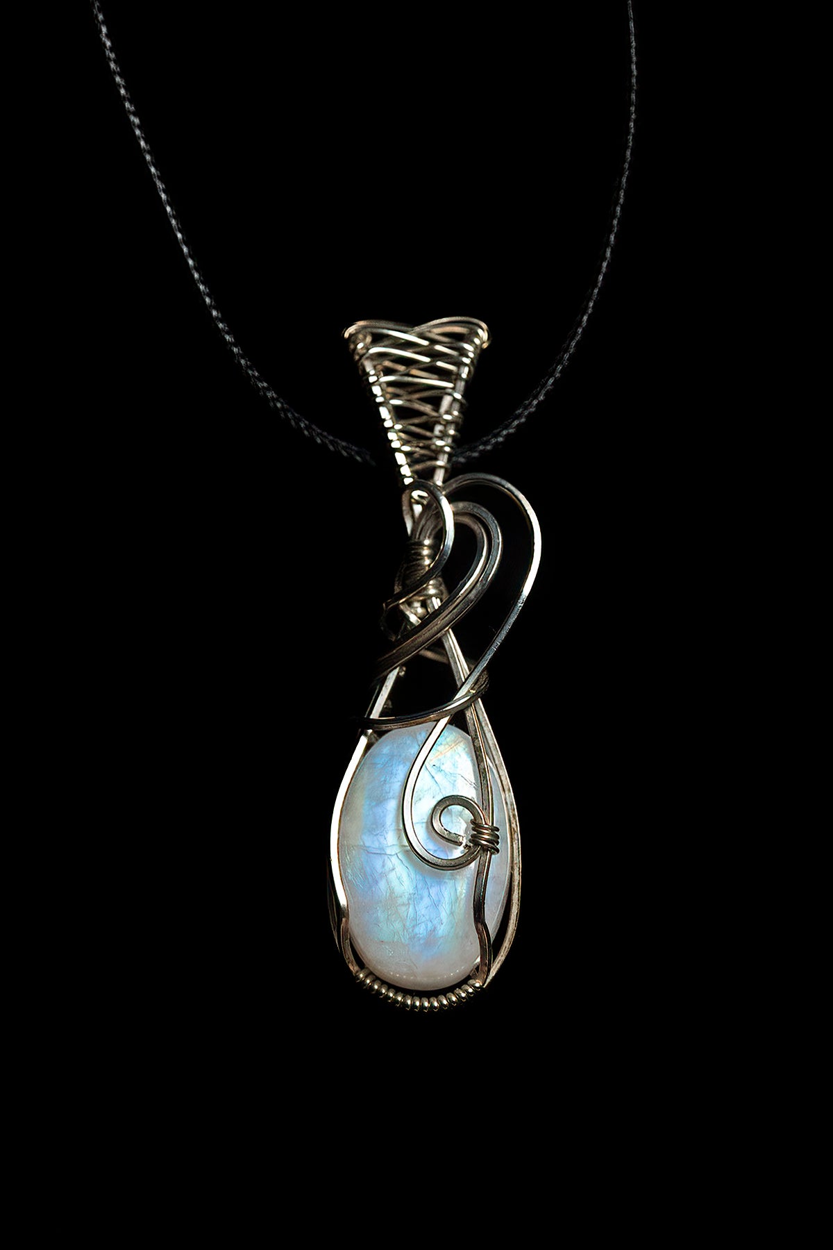 Thick, oval moonstone with fancy bale, wrapped in .925 sterling silver