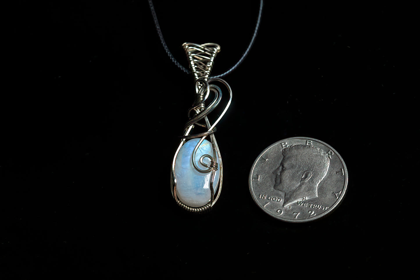 Thick, oval moonstone with fancy bale, wrapped in .925 sterling silver