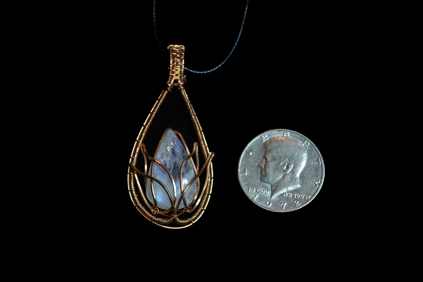 Translucent, blue flash Moonstone wrapped in Fine Copper Lotus Cage