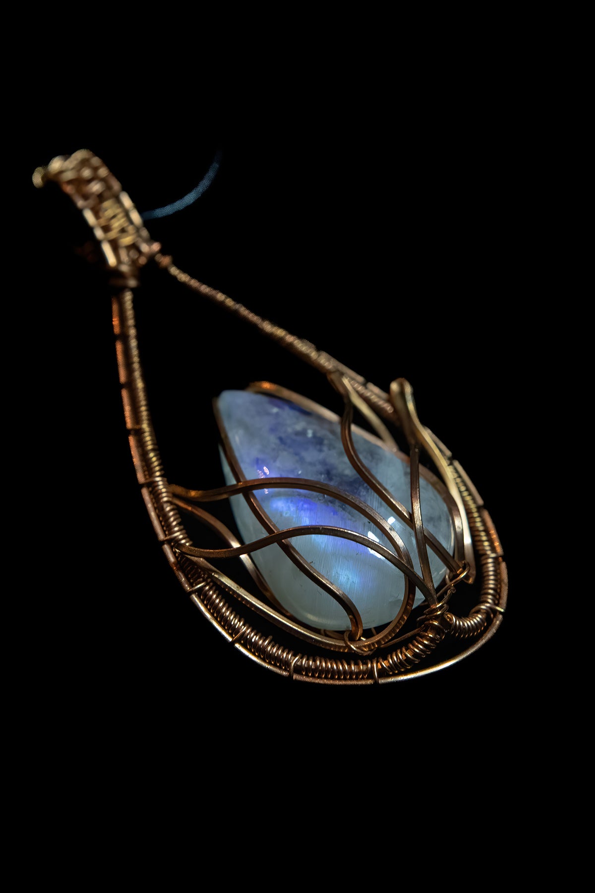 Translucent, blue flash Moonstone wrapped in Fine Copper Lotus Cage