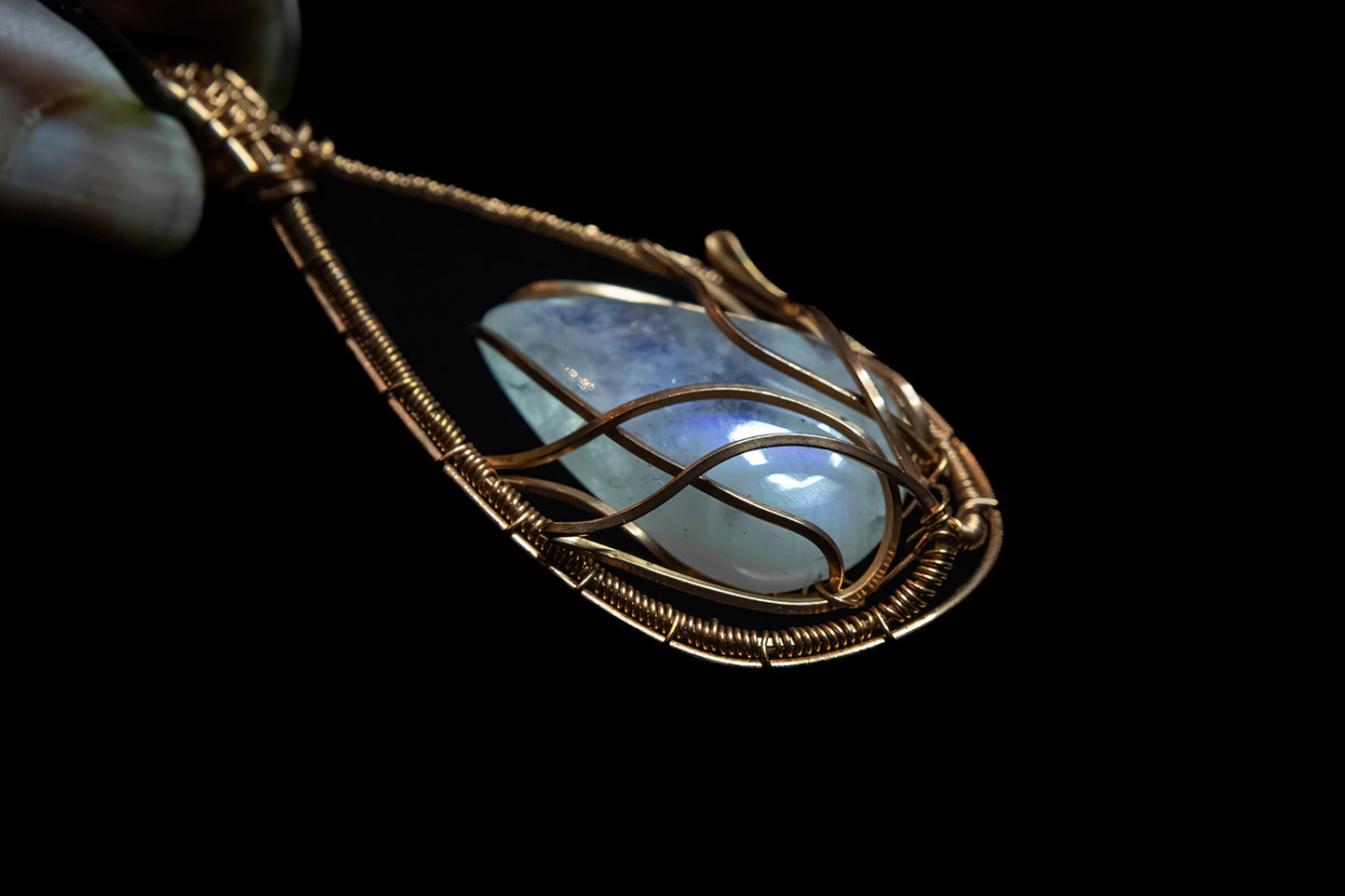 Translucent, blue flash Moonstone wrapped in Fine Copper Lotus Cage