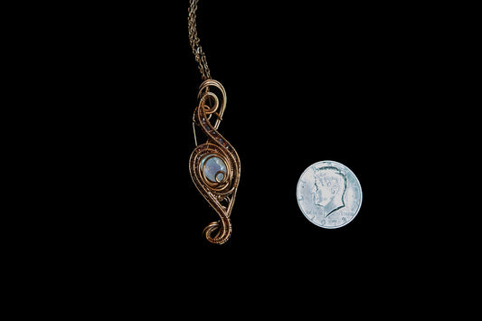 Faceted Madagascar Rainbow Flash Moonstone nestled in Fine Copper and surrounded by a multitude of Garnet Facets