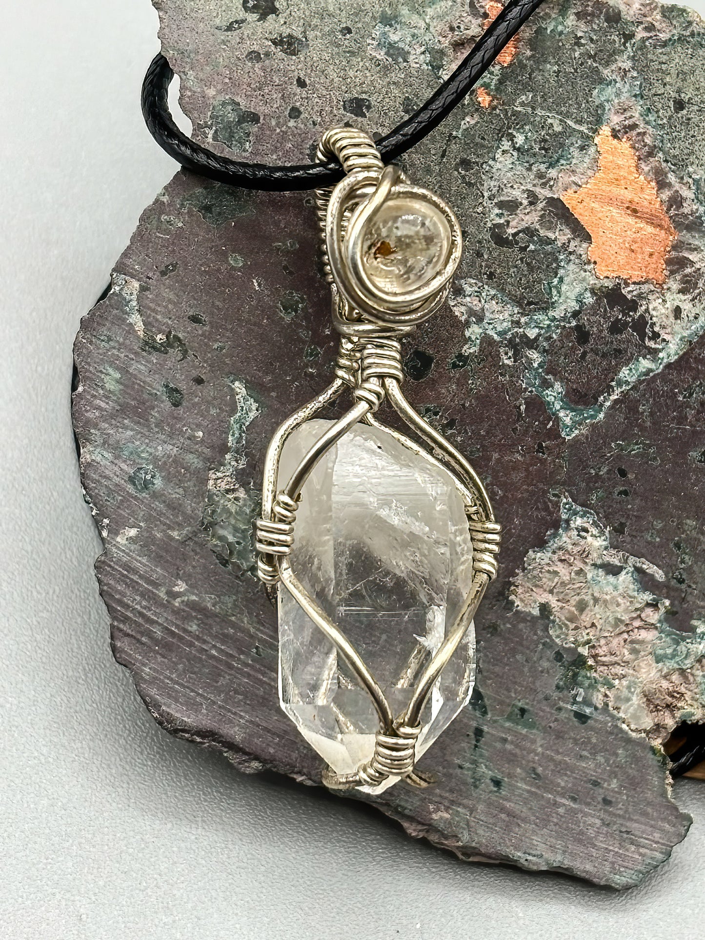 Self Mined Arkansas Quartz Point accented with Firefly Quartz from Brazil, wrapped in sterling silver